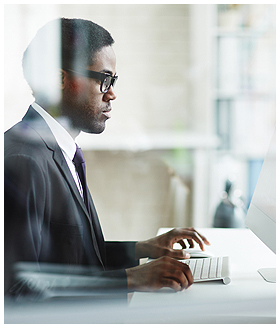 Businessman Using Computer in Workplace Businessman Using Computer in Workplace